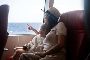 Mother and daughter pointing at sea during ferry journey, a Person Photo by etorres69
