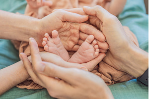 Newborn tiny feet surrounded by, a Person Photo by Elizaveta Galitskaya