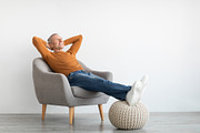 Mature man having rest at home on the chair, a Photo by Prostock-Studio (Thumbnail 1 of 2)