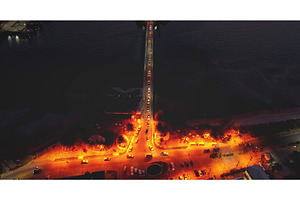 Cars driving at night on bridge over, a Transportation Photo by Goinyk
