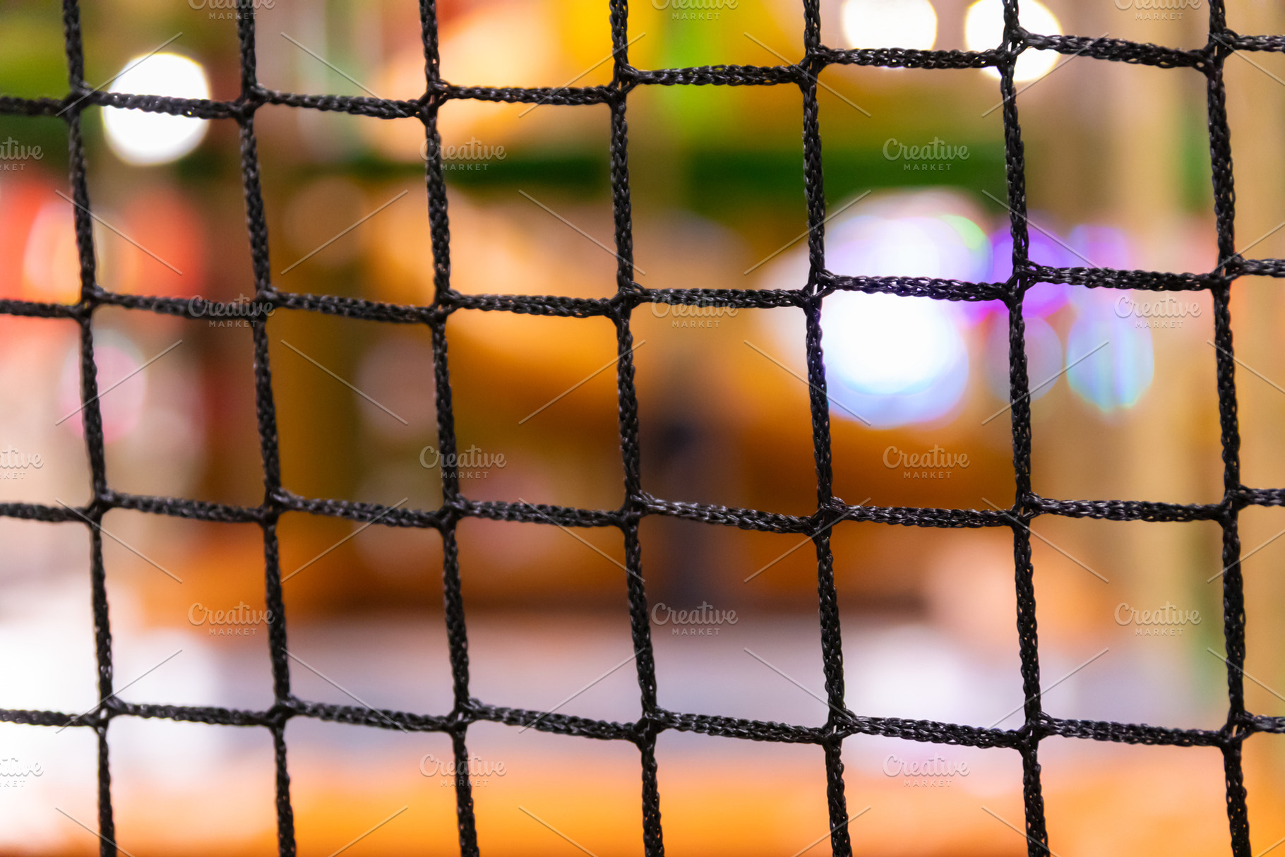 Close-up of a black net or mesh grid in sharp focus with a color, a Background Photo by Ales Munt