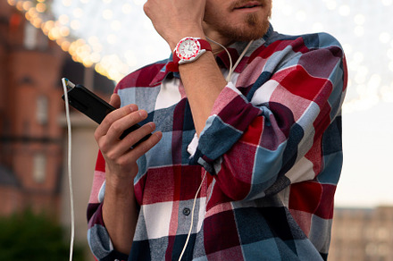 Man adjusting earphones while listen