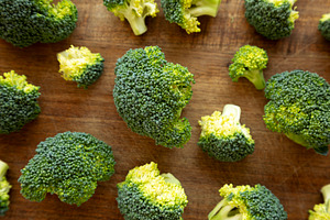 Raw Organic Green Broccoli on a Wooden Board, top view., a Food & Drink Photo by LiudmylaChuhunova