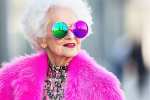 An older woman with white hair, oversized pink sunglasses, and a vibrant pink f, a Person Photo by Mashimara