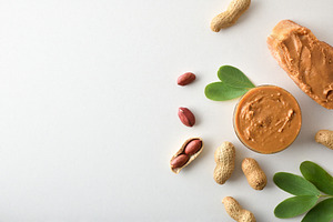 Peanut butter and slices of bread on a white table, a Food & Drink Photo by Davizro's Market