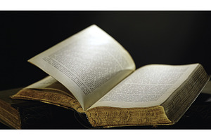 Open old book lying on the table, a School & Education Photo by Media Whale Stock