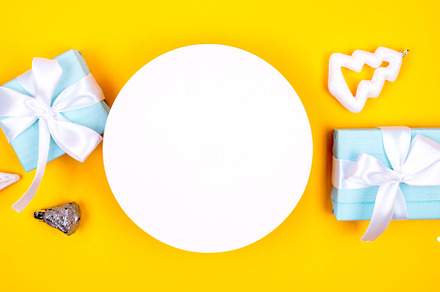Holidays gift box wrapped in blue paper, balls, glitter on yello, a Holiday Photo by vimart
