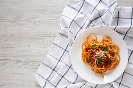 Homemade Bucatini all Amatriciana Pasta in a plate on a white wo, a Food & Drink Photo by LiudmylaChuhunova