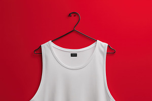 A plain white tank top mockup hanging on a hook against a vibrant red backgroun