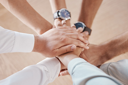 Business people, hands and team building motivation in support, trust and collaboration circle in office. Zoom on diversity men, planning women or global company meeting with goal and innovation idea, a Photo by Peopleimages.com