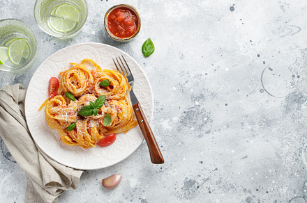 Tasty appetizing classic italian tagliatelle pasta with tomato sauce, cheese pa, a Food & Drink Photo by Budarinphoto