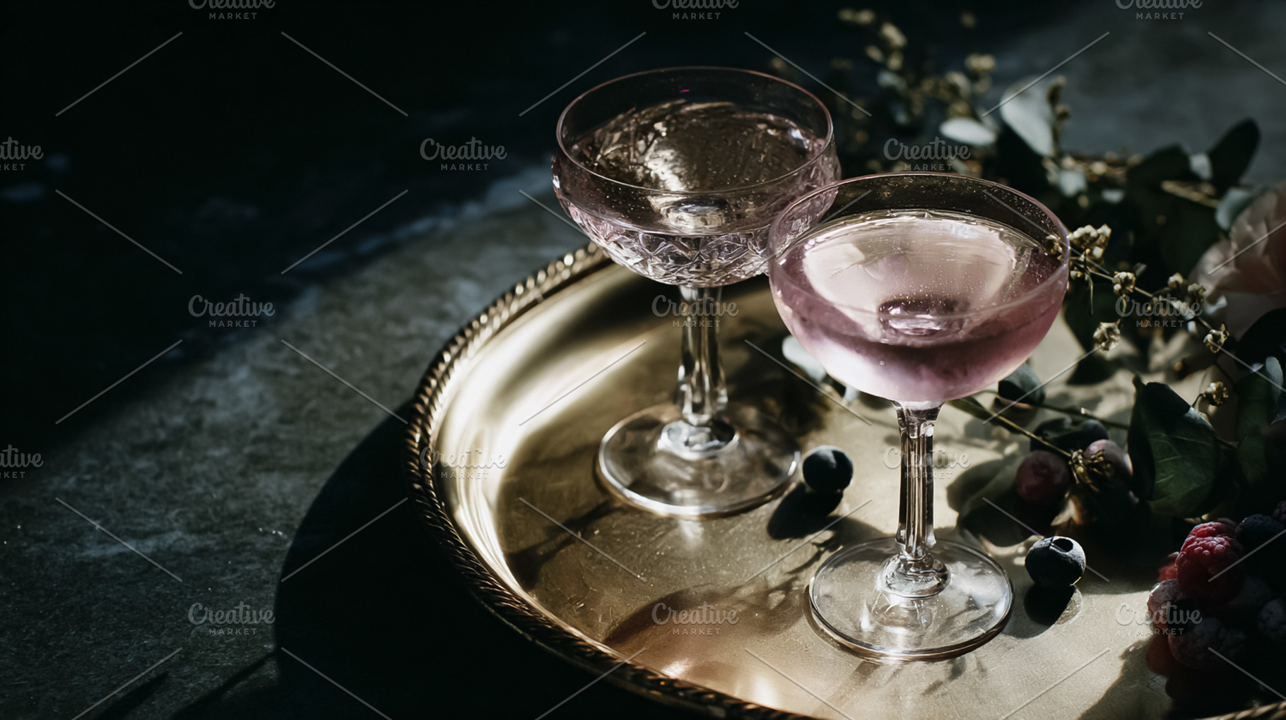 Sparkling pink cocktails on brass tray with fresh berries and eu, a Photo by Studio ANNA