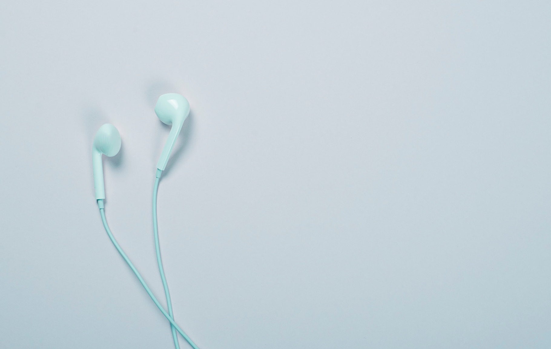 Headphones on blue background. Technology., a Technology Photo by José Luis Agudo