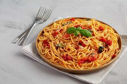 Homemade Spaghetti With Fresh Tomato Sauce on a Plate, side view, a Food & Drink Photo by LiudmylaChuhunova