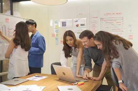 A group of multi ethnic business team talk, communicate, discuss, a Photo by Tampatra