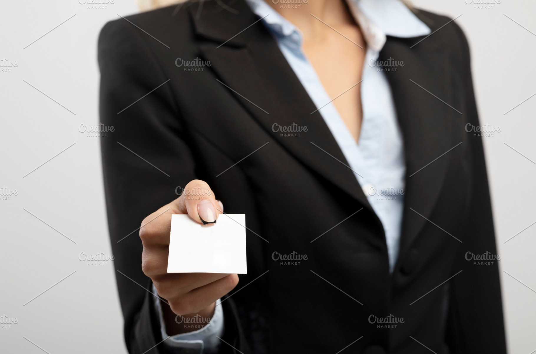 Cropped view of businesswoman giving empty business card with mockup for design, a Photo by Prostock-Studio