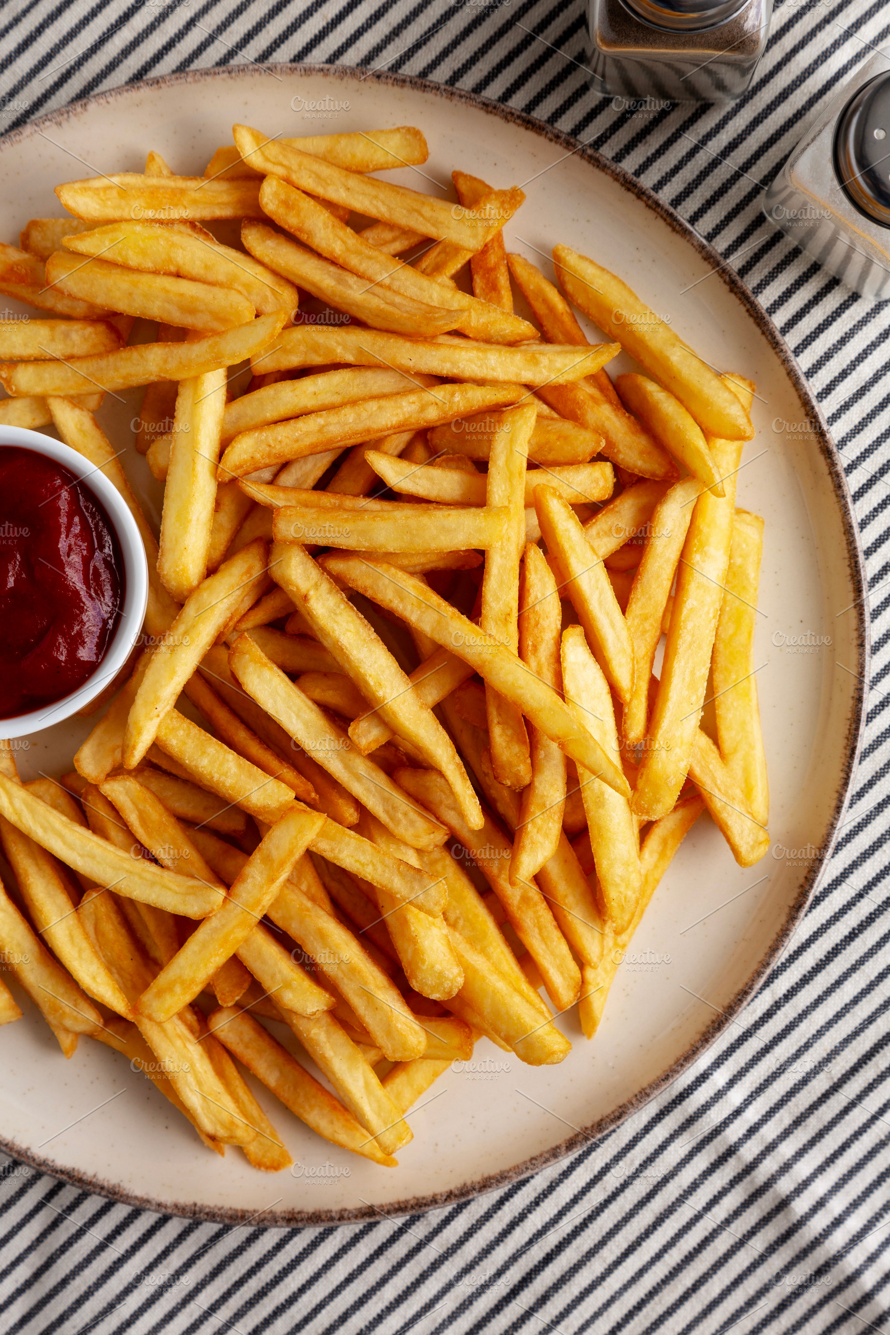 Homemade Golden French Fries with Ketchup, top view. Close-up., a Food & Drink Photo by LiudmylaChuhunova