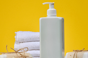 White square bottle with dispenser and stack of folded white tow, a Beauty & Fashion Photo by ndanko