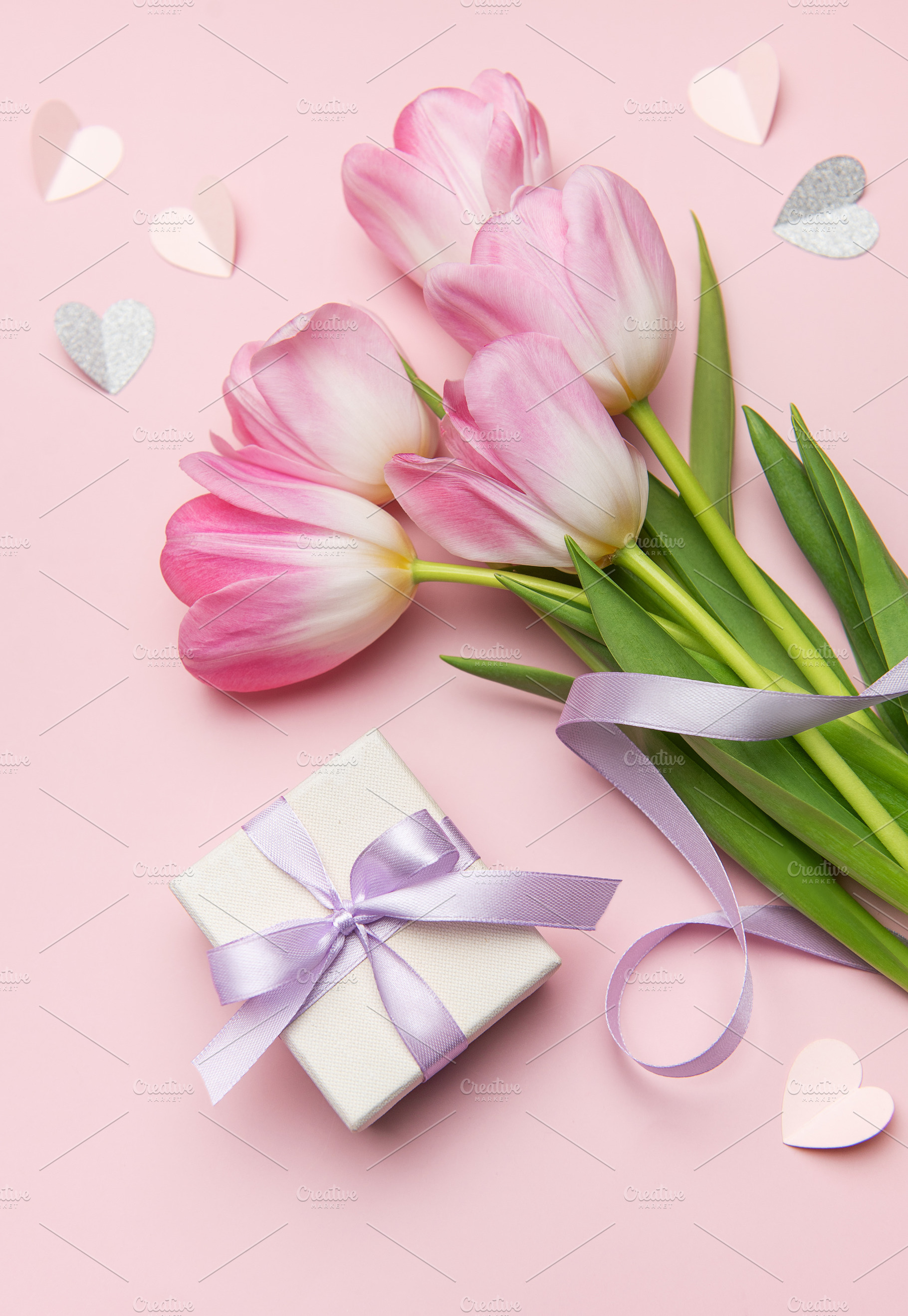 Pink tulips and gift box on pink background for mother's day or, a Holiday Photo by Olena Rudo