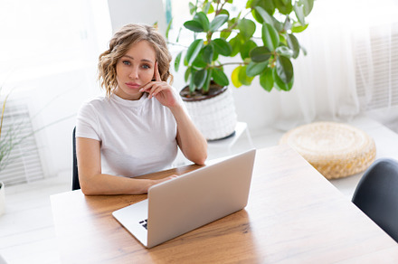 Business woman using laptop sitting near desk white office interior with housep, a Person Photo by andreonegin market