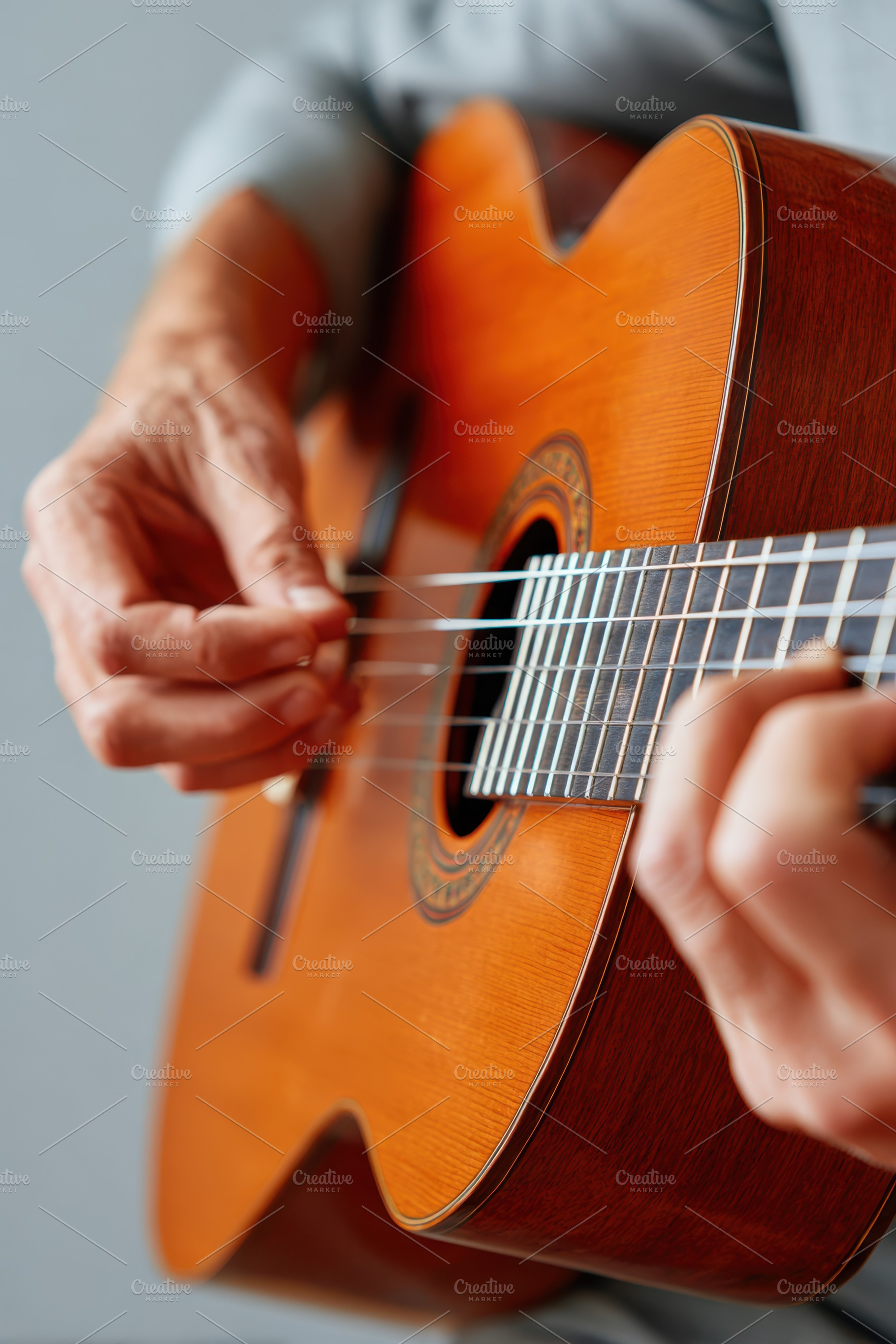Close-up of hands playing an acoustic guitar, an Arts & Entertainment Photo by AlyaAnd