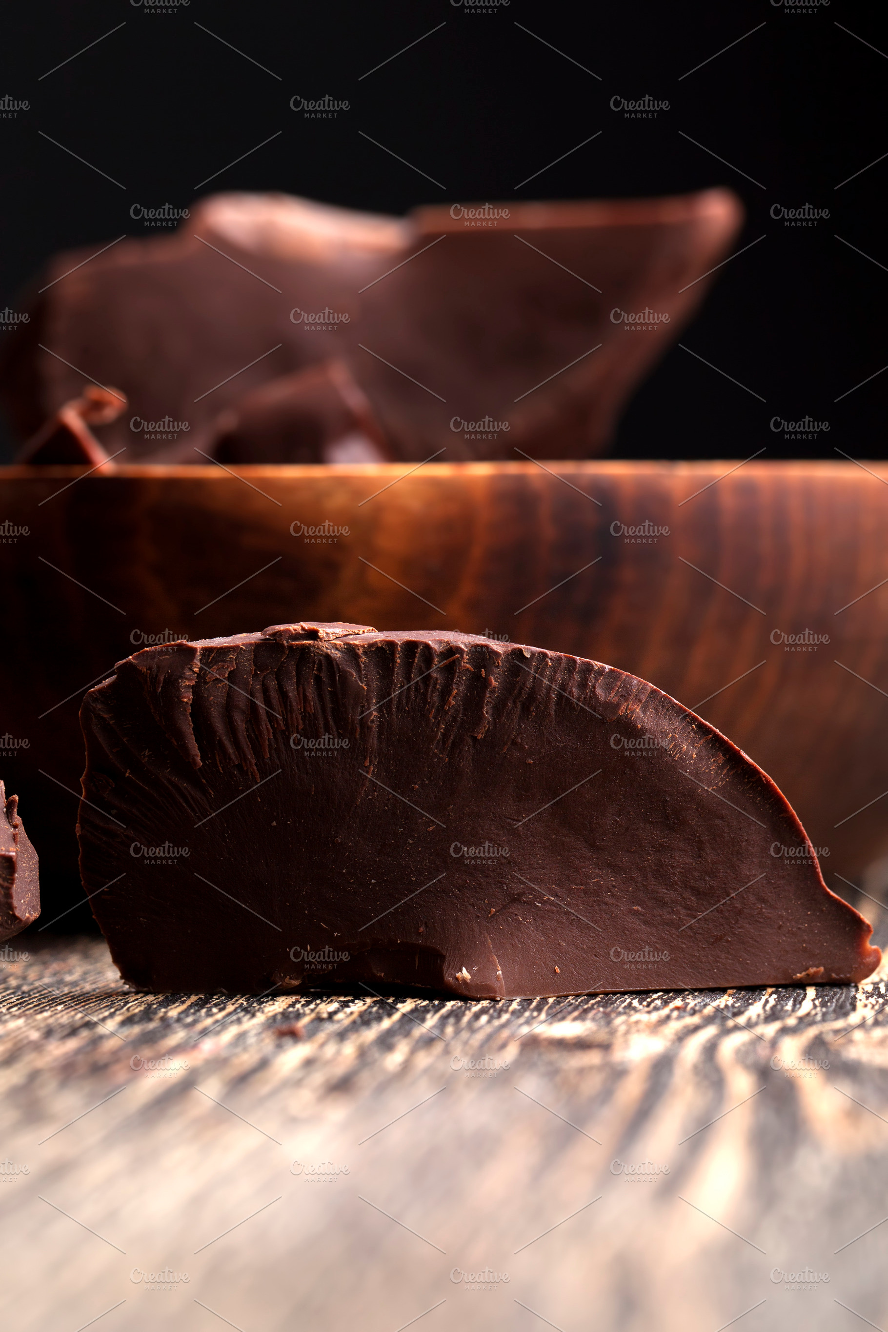 divided into pieces a piece of chocolate from cocoa, a Background Photo by MyPhotos