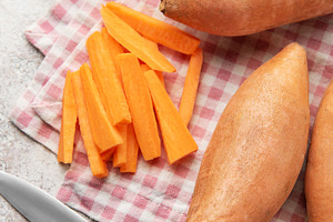 Preparing sweet potato fries with knife and basil on napkin, a Food & Drink Photo by Olena Rudo