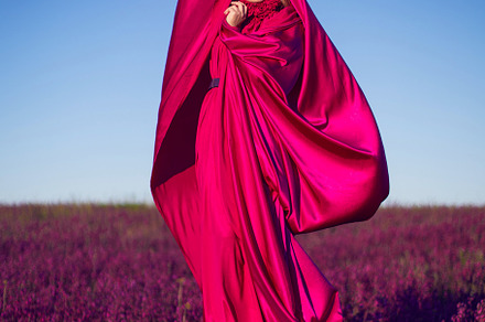 fashionable beautiful young woman on a pink stepladder in a pink dress in a fie, a Person Photo by SaulichPhoto