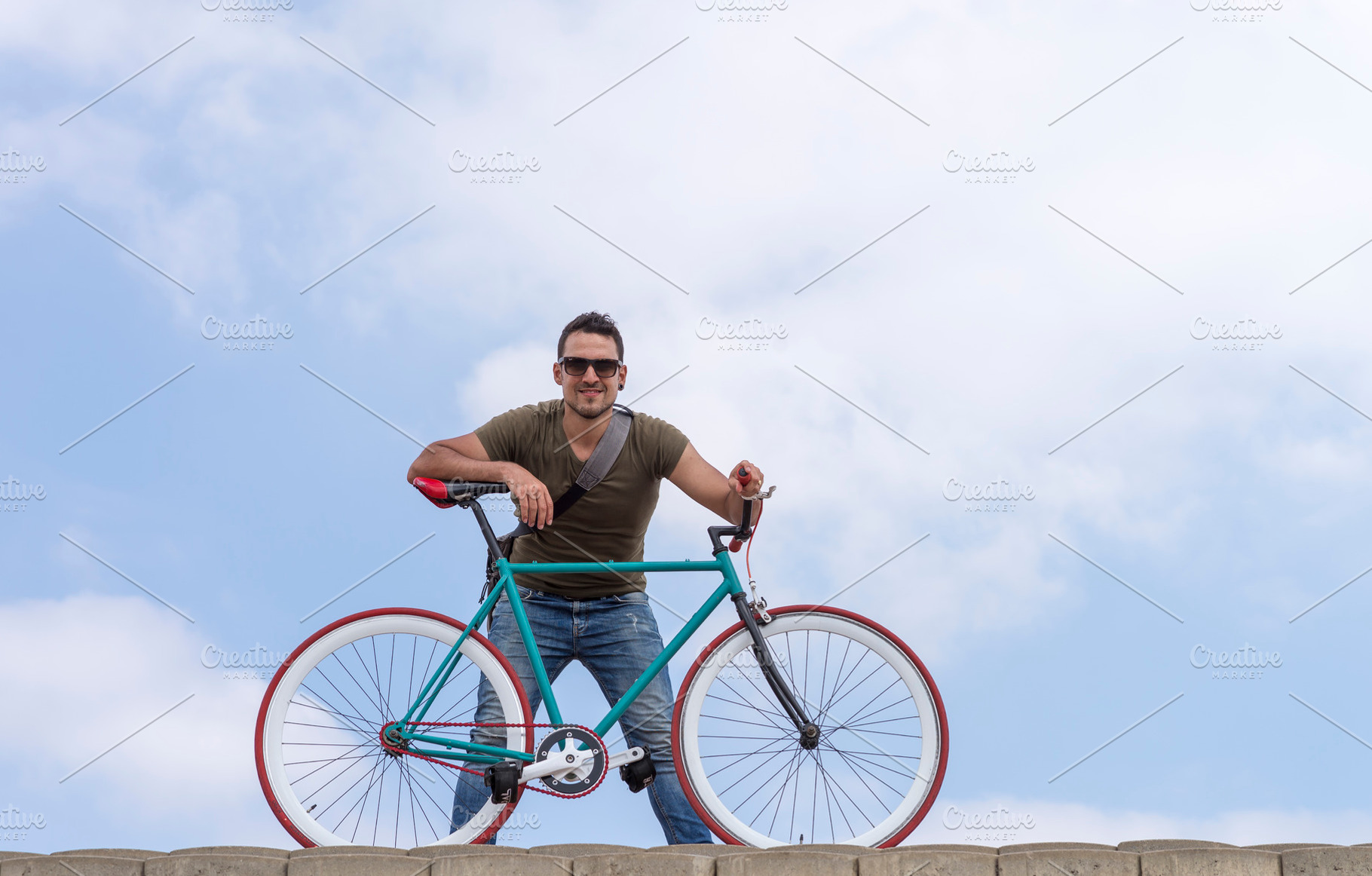 Urban man wearing sunglasses on a cloudscape, a Holiday Photo by 2Design