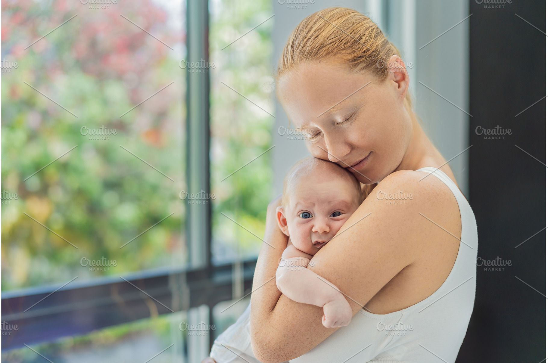 Mother gently hugging her baby at, a Person Photo by Elizaveta Galitskaya