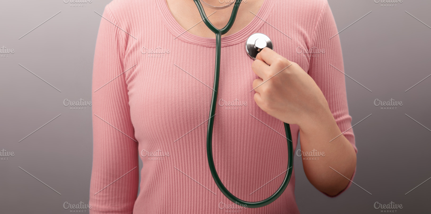 Woman touching chest with heart and stethoscope symbol. Self awa, a Photo by salmon.black