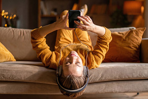 Young Woman Relaxing with Smartphone and Headphones, a Photo by Davizro's Market