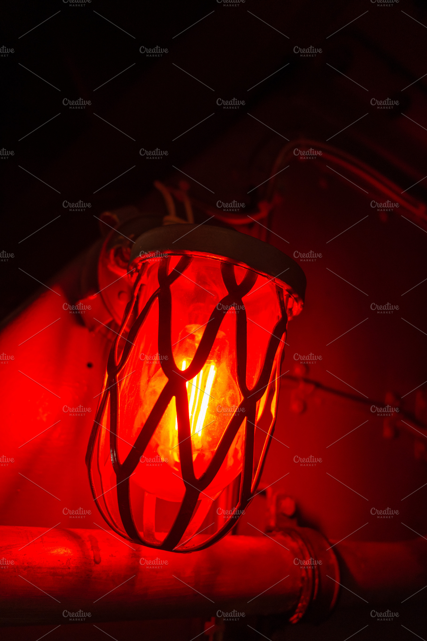 Red alarm light inside an old military submarine with protective, a Background Photo by GoodGoods