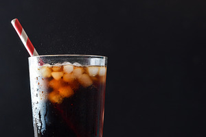 Detail of glass with cola drink with ice isolated background, a Food & Drink Photo by Davizro's Market