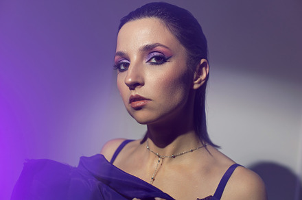 portrait of a brunette woman in a purple dress on white background in the studi, a Person Photo by SaulichPhoto