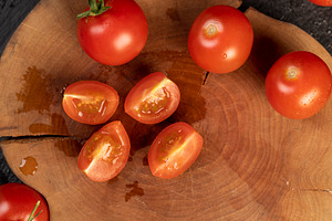 cut tomatoes sliced on a board, several ripe red tomatoes during slicing for co, a Photo by rsoollAI