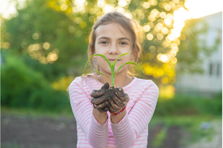The child is planting a plant in the, a Nature Photo by yanadjana