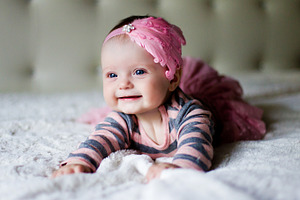 Baby girl lying on her stomach featuring adorable, baby, and beautiful