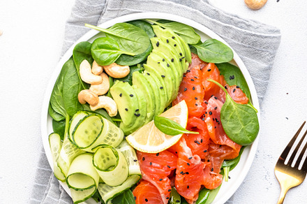 Keto salad with salmon, avocado, spinach, cucumber, sesame seeds, a Food & Drink Photo by 5PH