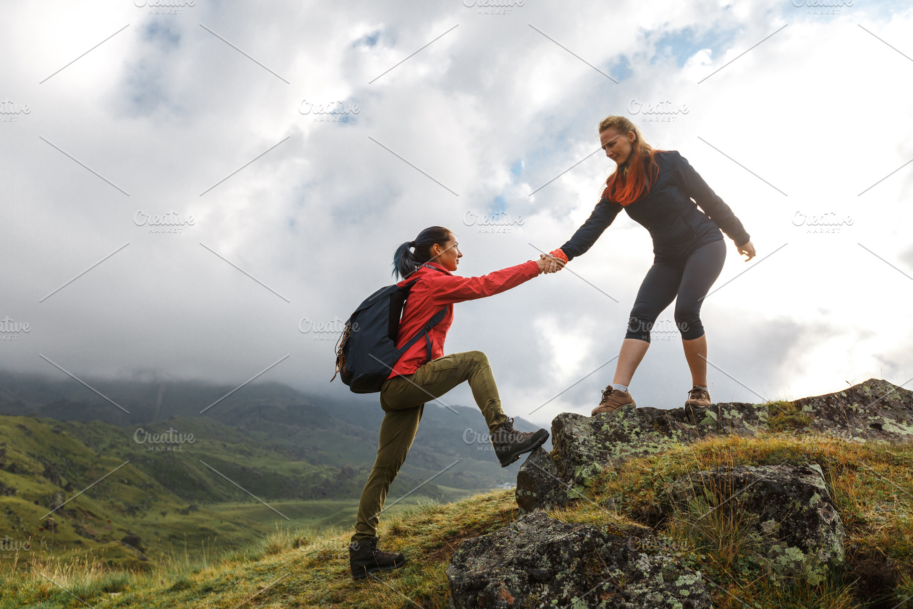 Girls helping each other hike up a m, a Person Photo by Tinyakov Story
