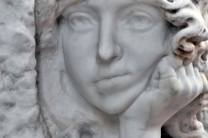 boring face of an angel in the cemetery
