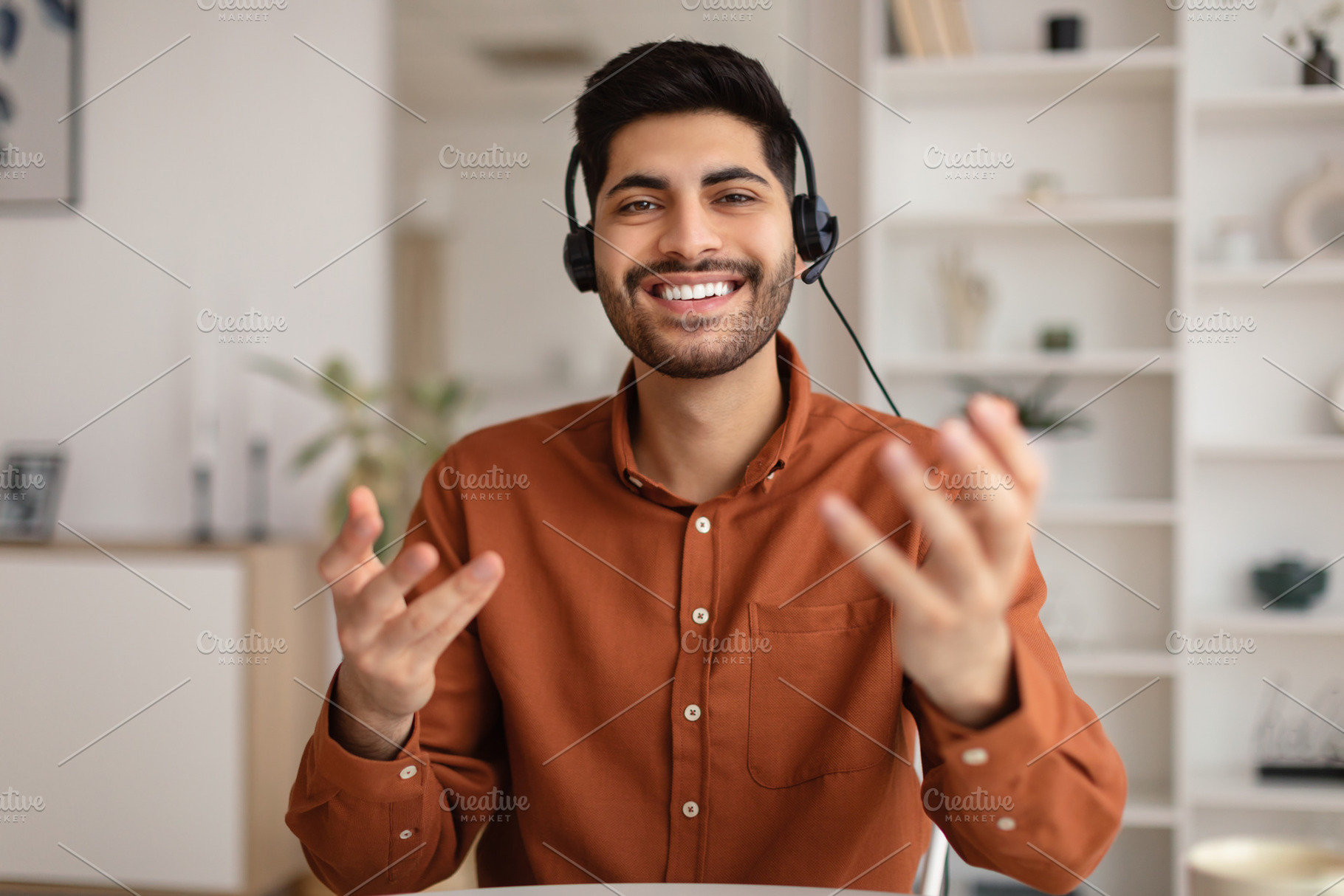 Arab man having video call and talking at webcam, a Photo by Prostock-Studio