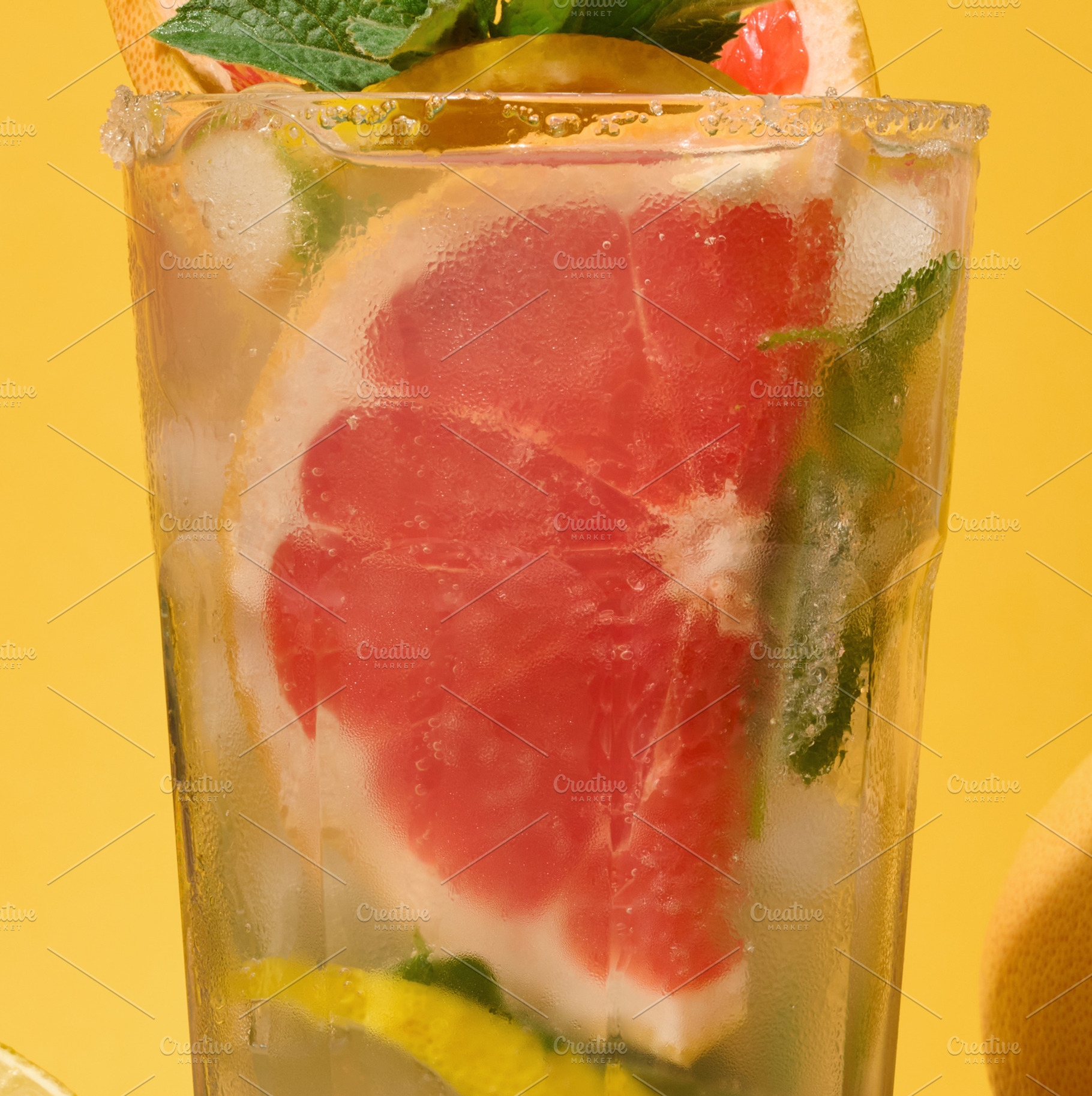 Top of clear glass with cold drink, grapefruit slices, ice and m, a Food & Drink Photo by ndanko