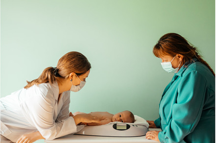 Baby on weight scale at the doctor, a Person Photo by oksix