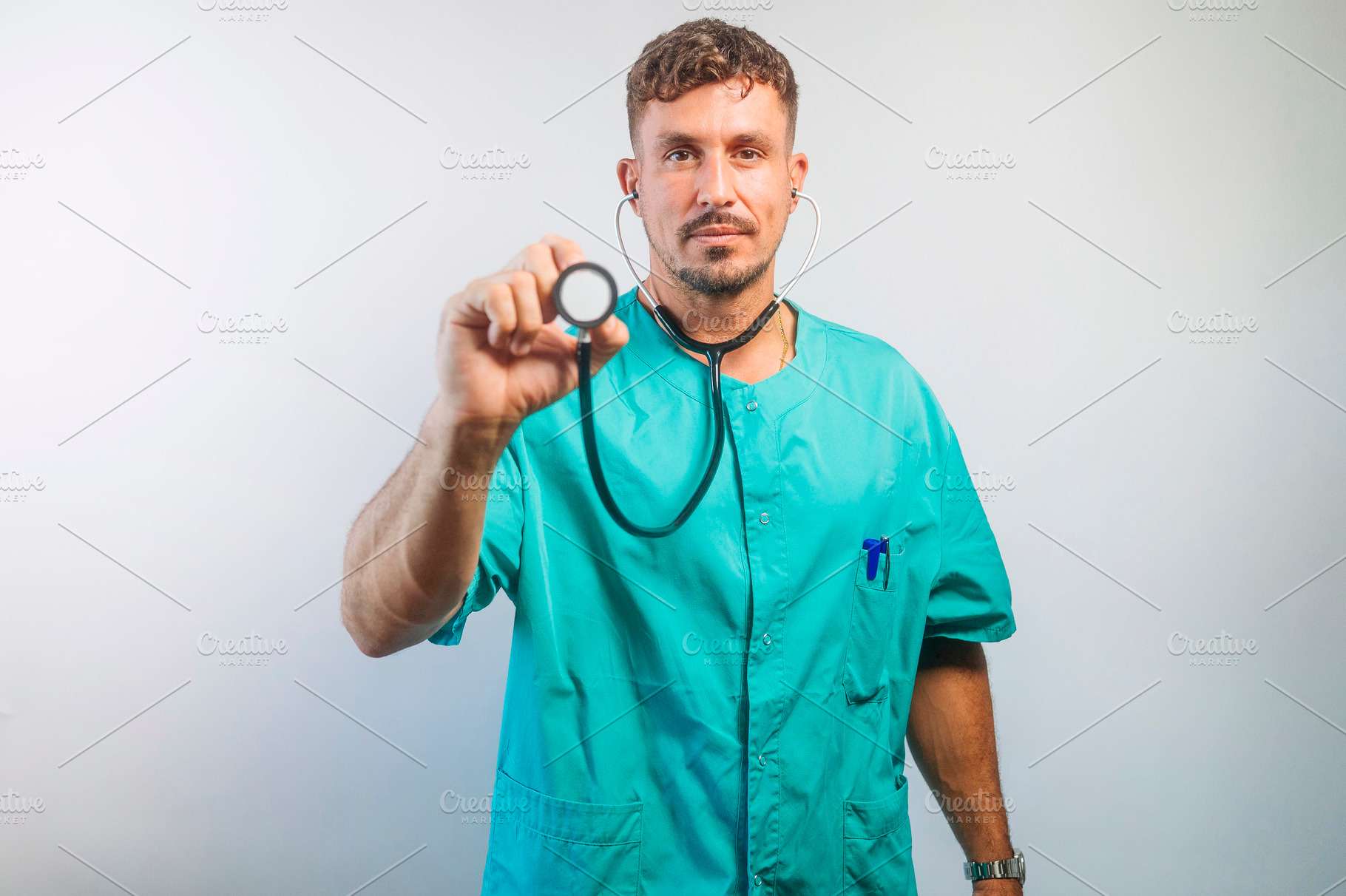 Serious Doctor Holding Stethoscope Forward, a Person Photo by karrastock