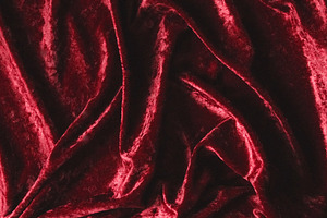 Red velvet fabric background showing soft luxurious texture and draped folds of, a Photo by Studio ANNA