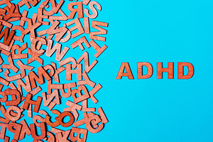 Word adhd from wooden letters on a b containing adhd, deficit, and diagnosis