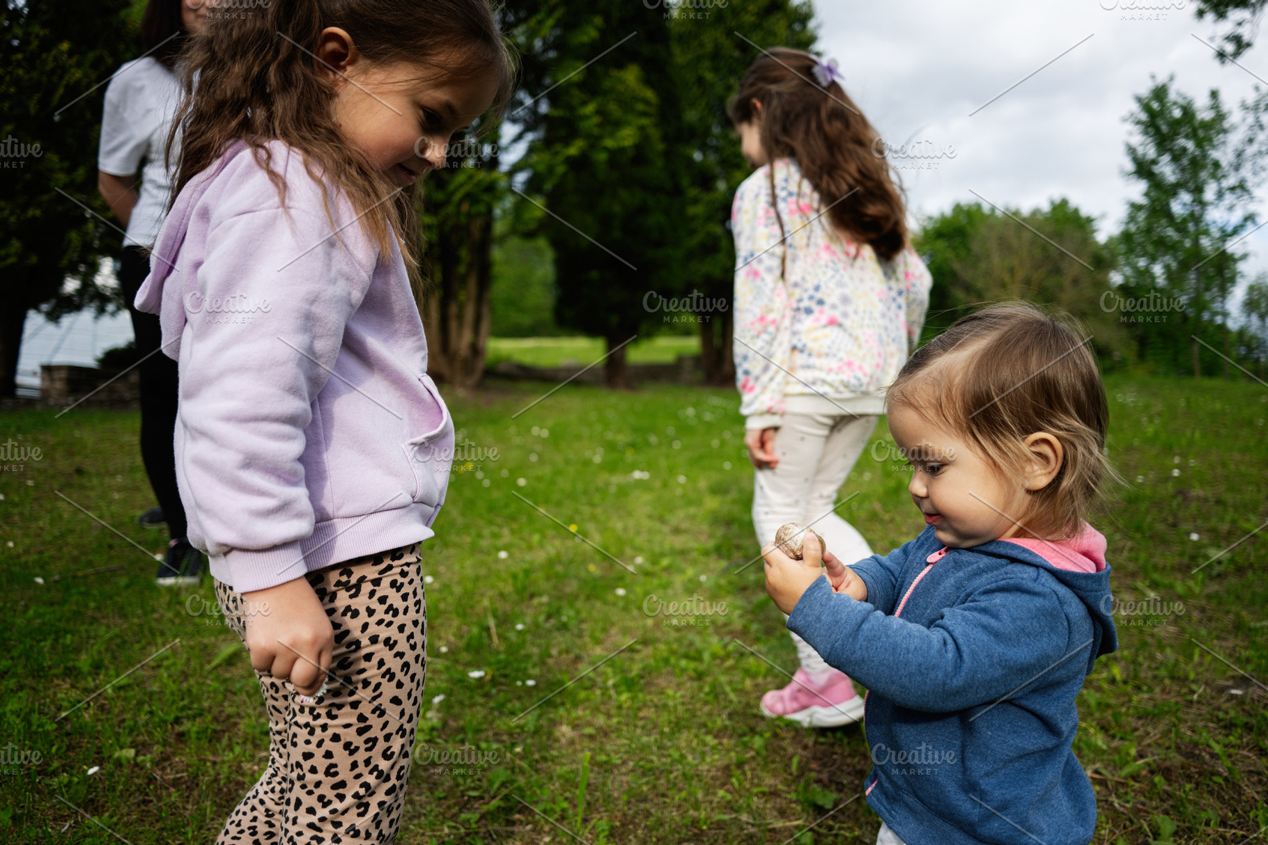 Children playing outdoors on a sunny day in a natural grassy environment, a Person Photo by AS photostudio