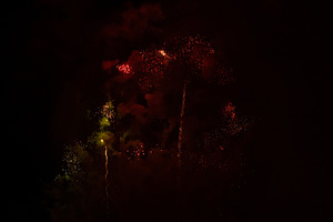 Fireworks exploding behind a wall of smoke