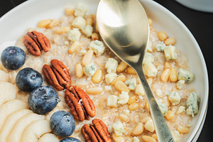 Oatmeal. Bowl of oatmeal porridge with blackberry, bananas and chia seeds on gr, a Food & Drink Photo by Budarinphoto